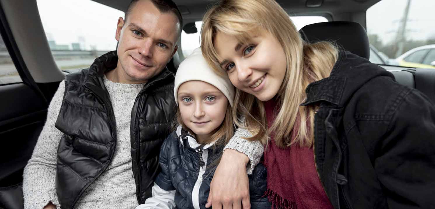 Couple with their Kid in a Car - benefits of Monthly Safe Driver Booking