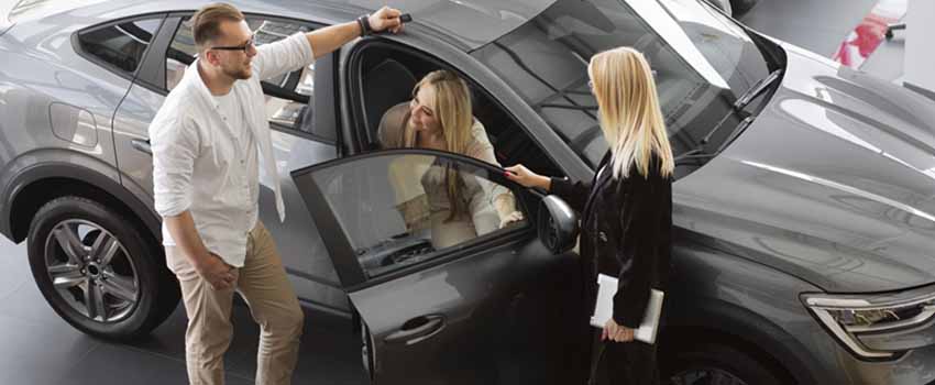 Foreigner Couple with Car Rental Woman Agent Checking for Renting a Car in Dubai