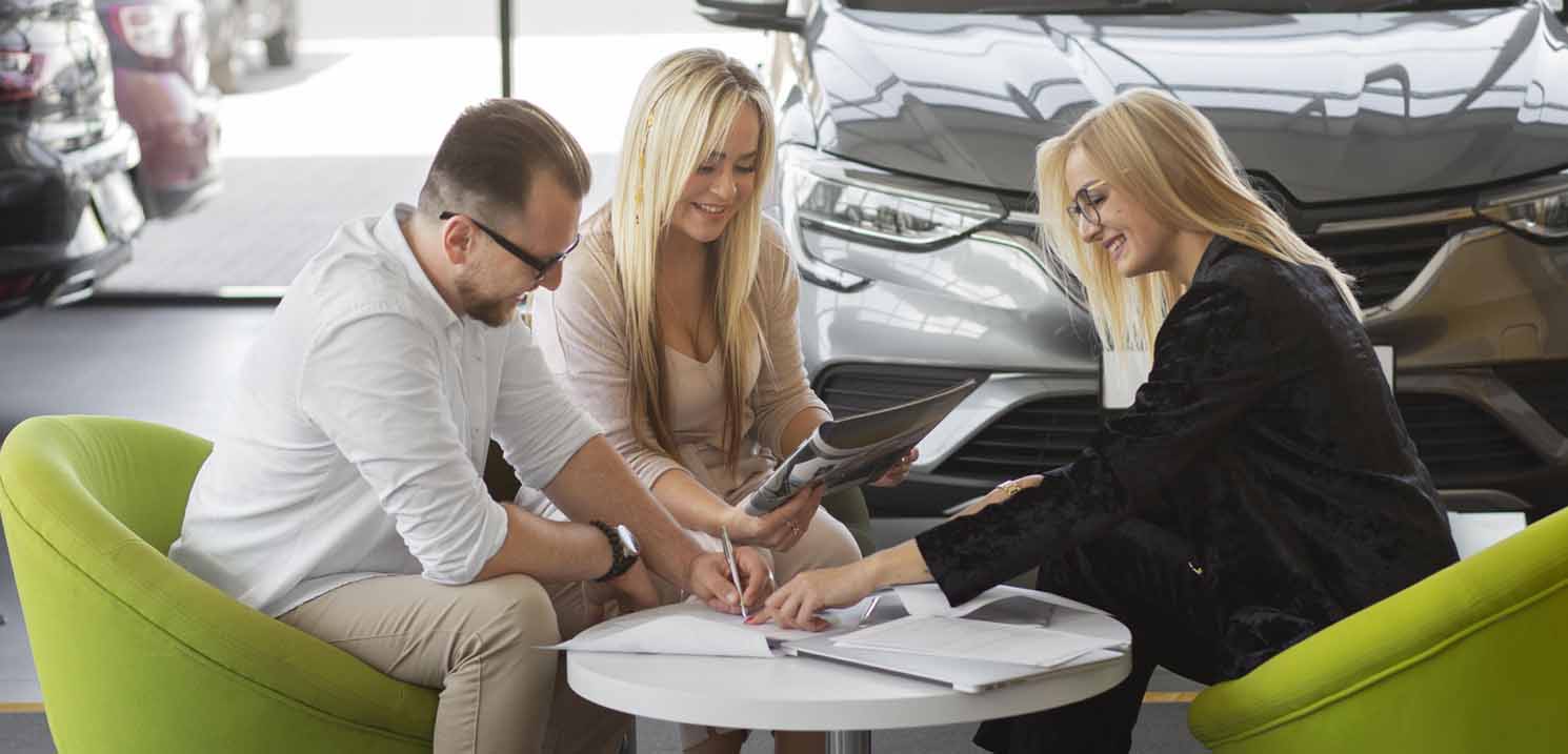Foreigner Couple with Car Rental Woman Agent Signing to Rent a Car in Dubai
