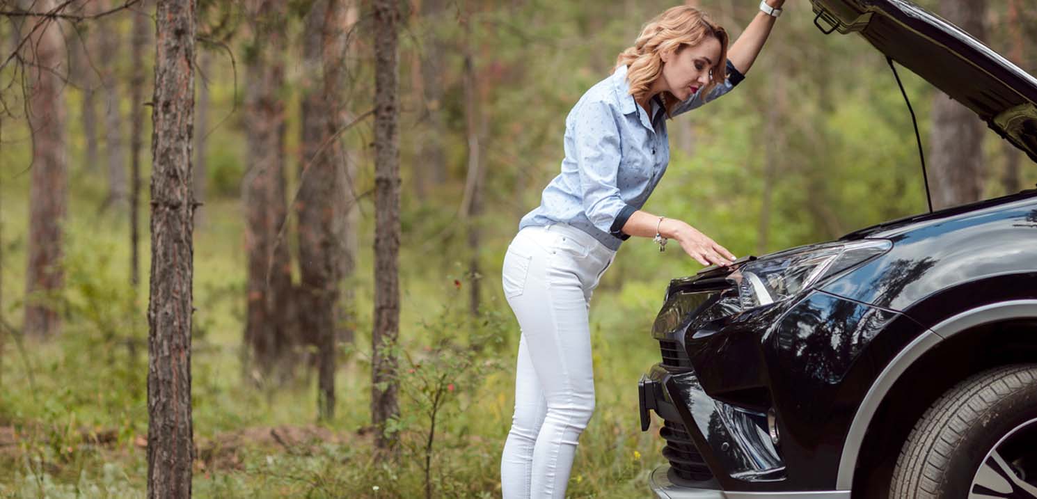 How to Prepare Car for Dubai Rainy Season - Woman Checking Vehicle Battery